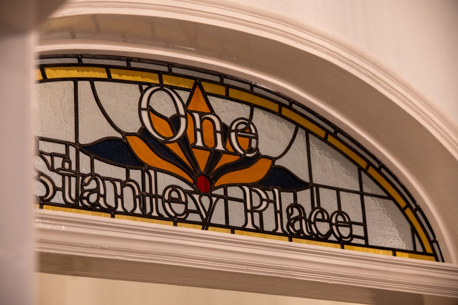 Stained glass window reading One Stanley Place